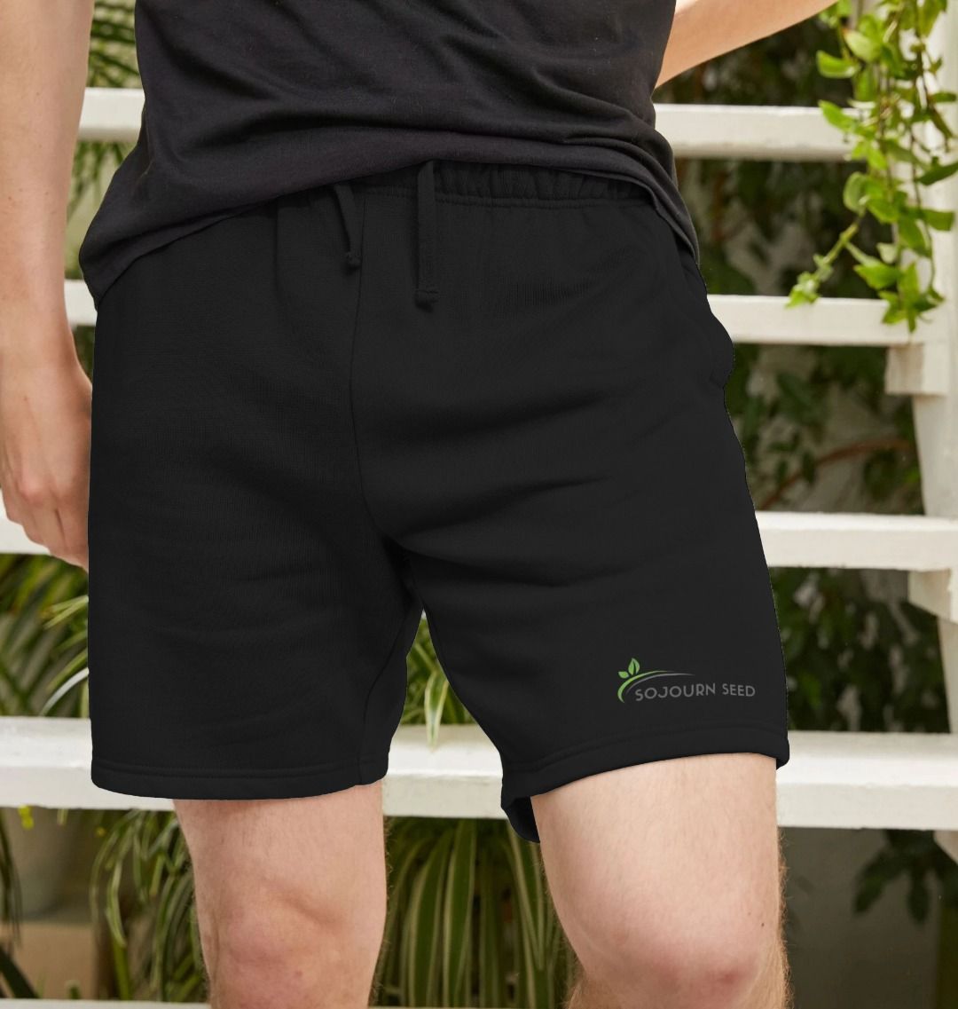 Black printed men's casual shorts by Sojourn Seed with elastic waistband and logo detail
