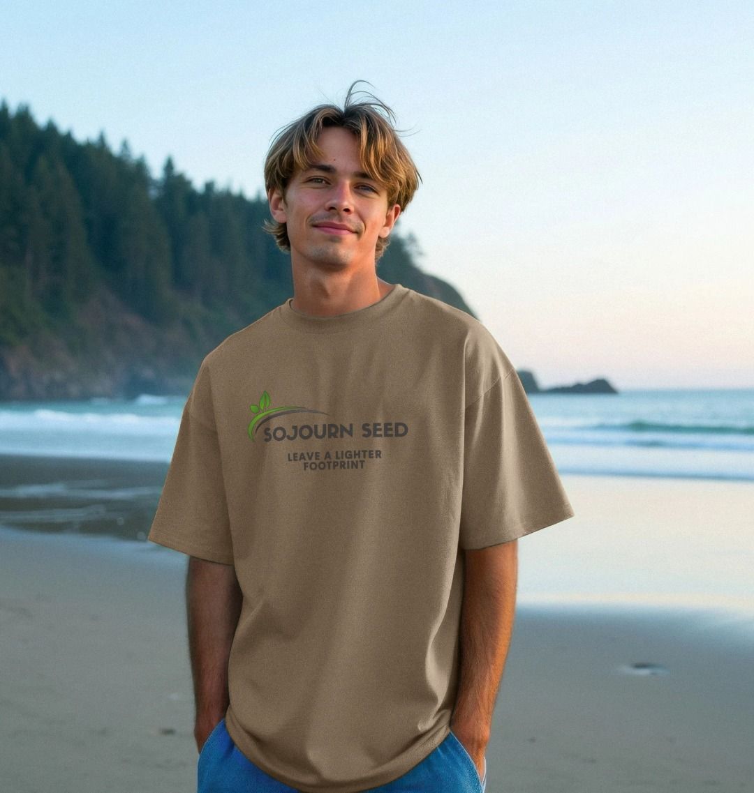 Sojourn Seed printed organic men's t-shirt in tan worn by man on beach with ocean background